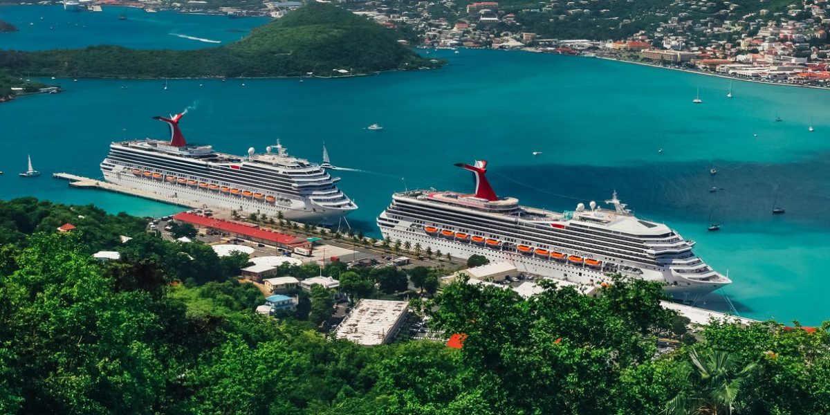 Saint Thomas / US Virgin Islands - October 31.2007: Aerial view of the Charlotte Amalie port with cruise ships docked. Deep blue sky with clouds, sunny day, turquoise color sea, green hills around.